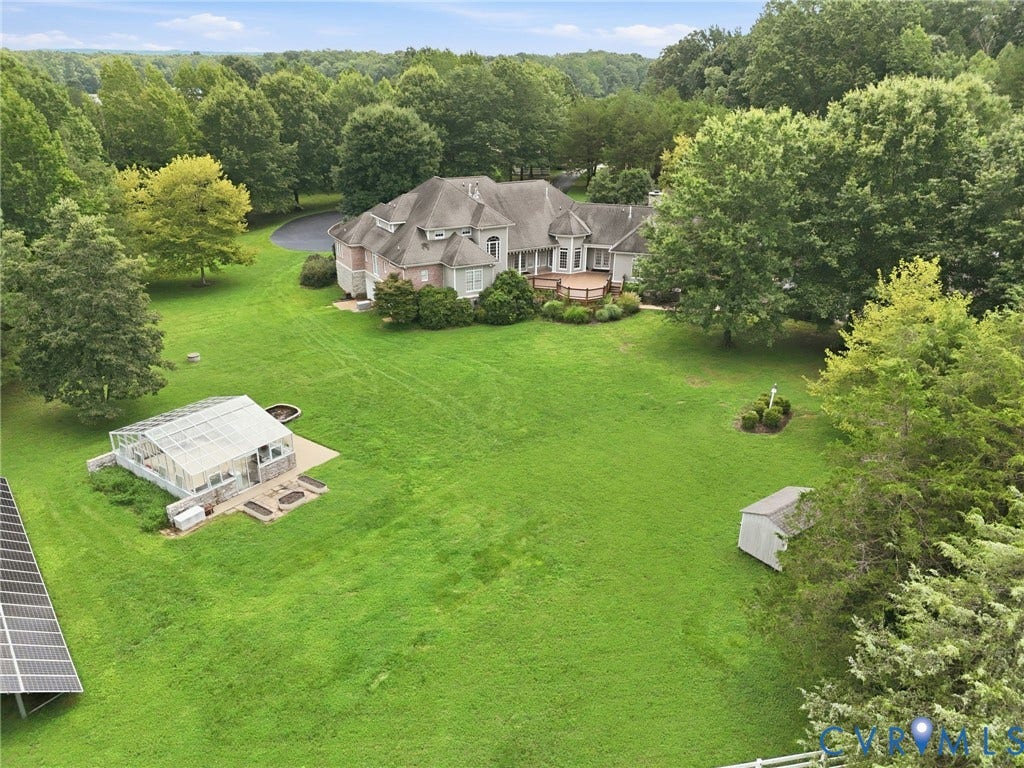 2365 Manakintown Ferry Road, Powhatan, VA 23113 Expansive property featuring a multi-level residence with a large deck, detached greenhouse, and solar panel array