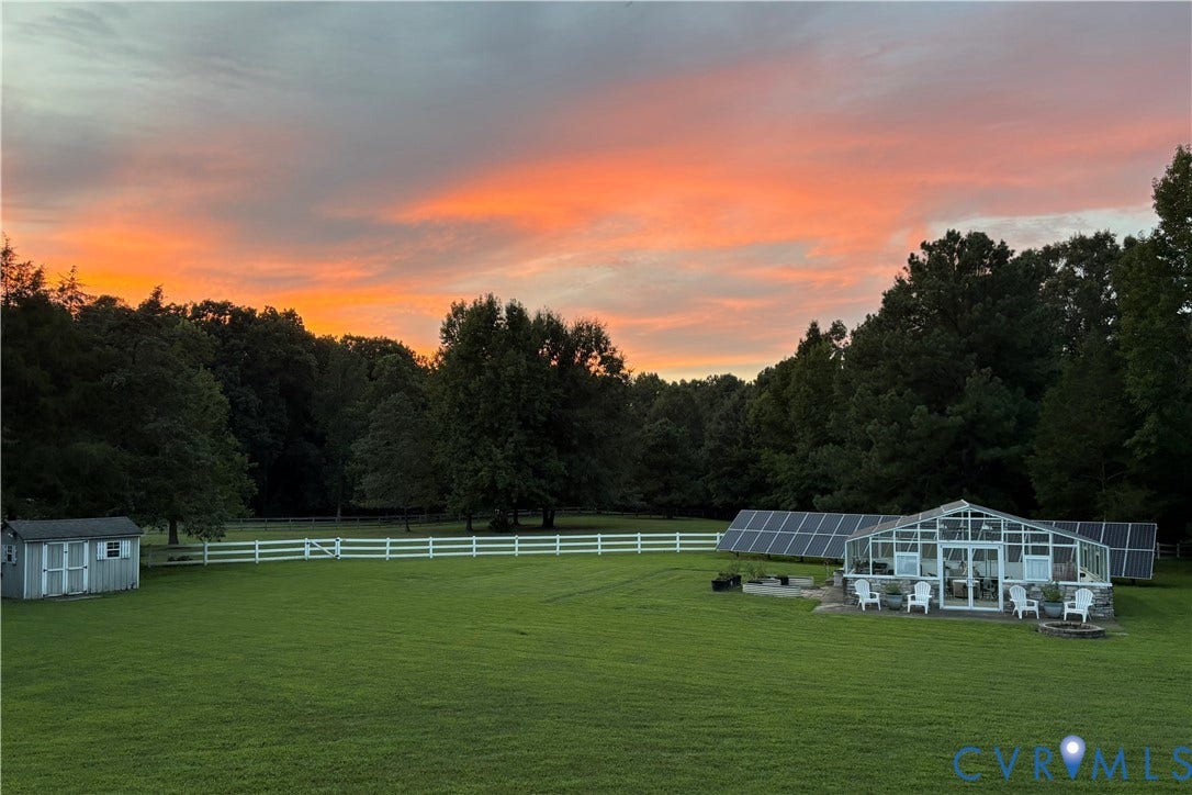 2365 Manakintown Ferry Road, Powhatan, VA 23113 Expansive grassy area with a white fence, a greenhouse structure, and multiple solar panels