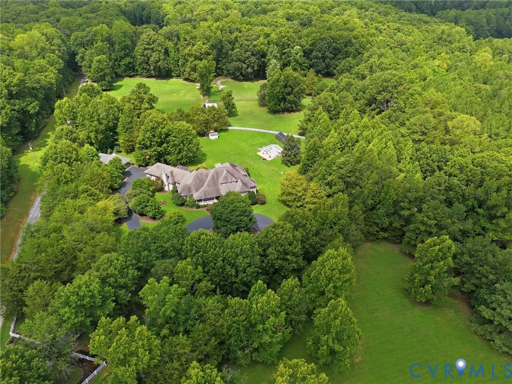 2365 Manakintown Ferry Road, Powhatan, VA 23113 Stately residence nestled on expansive wooded grounds featuring mature trees, manicured lawns, and extensive landscaping