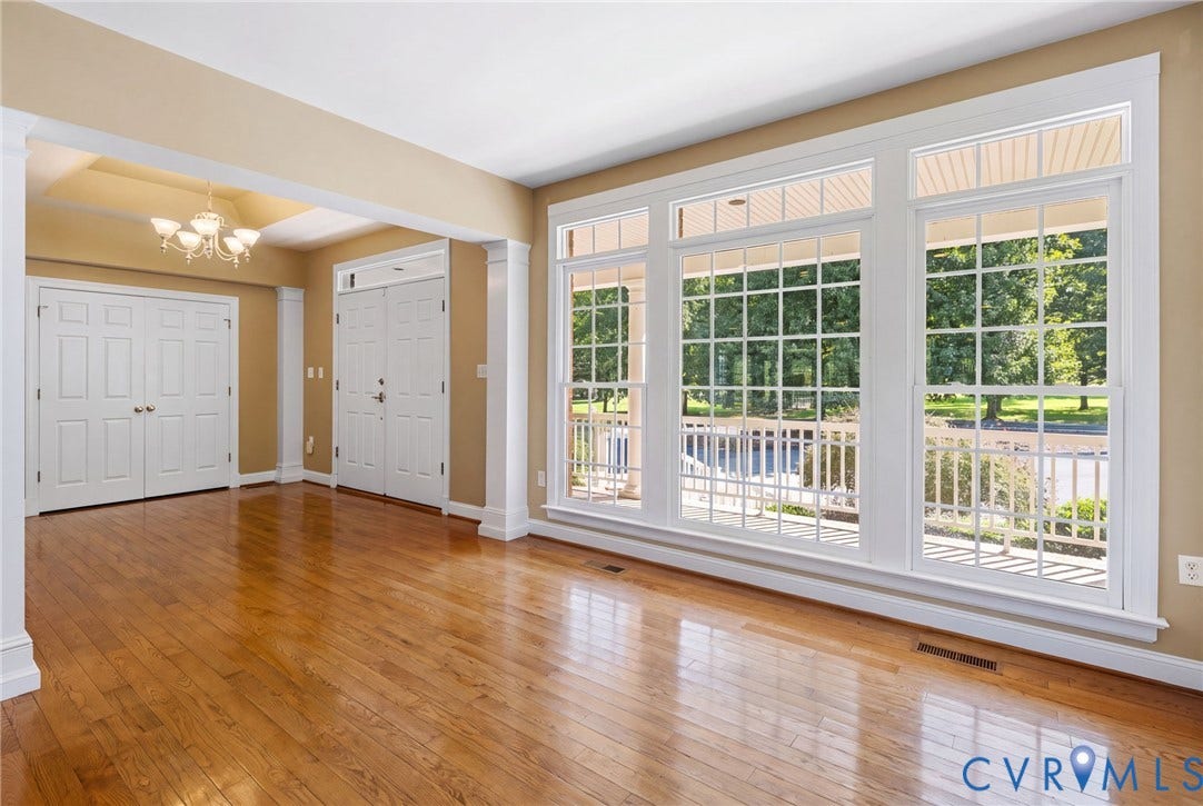 2365 Manakintown Ferry Road, Powhatan, VA 23113 Hardwood flooring throughout, coffered ceiling, chandelier, bright windows with grid patterns, and white trim