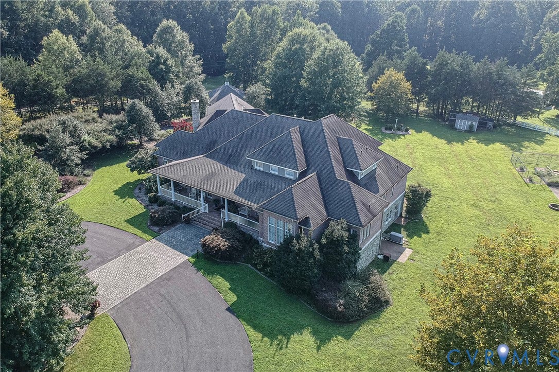 2365 Manakintown Ferry Road, Powhatan, VA 23113 Expansive property featuring a large residence with multiple gables, a covered front porch, and a paved driveway leading to a stone paver entrance