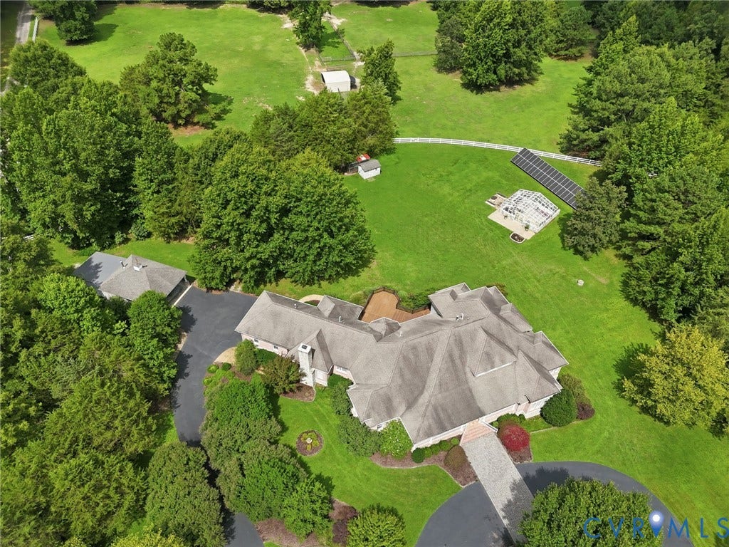 2365 Manakintown Ferry Road, Powhatan, VA 23113 Extensive property featuring a residential structure, detached garage, paved driveway, solar panel array, and a greenhouse