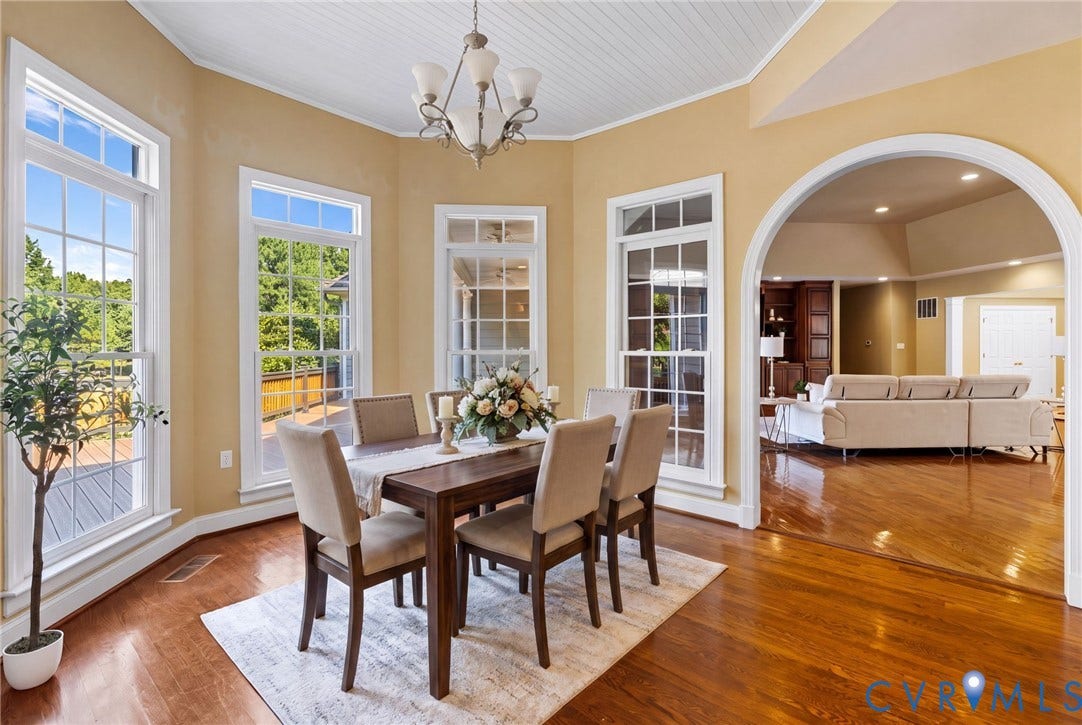2365 Manakintown Ferry Road, Powhatan, VA 23113 Hardwood flooring, arched doorway, coffered ceiling, multiple windows, and a chandelier