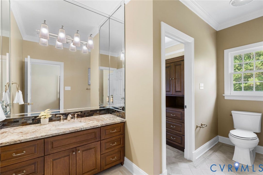2365 Manakintown Ferry Road, Powhatan, VA 23113 Vanity with a solid surface countertop, undermount sink, and multi-light fixture