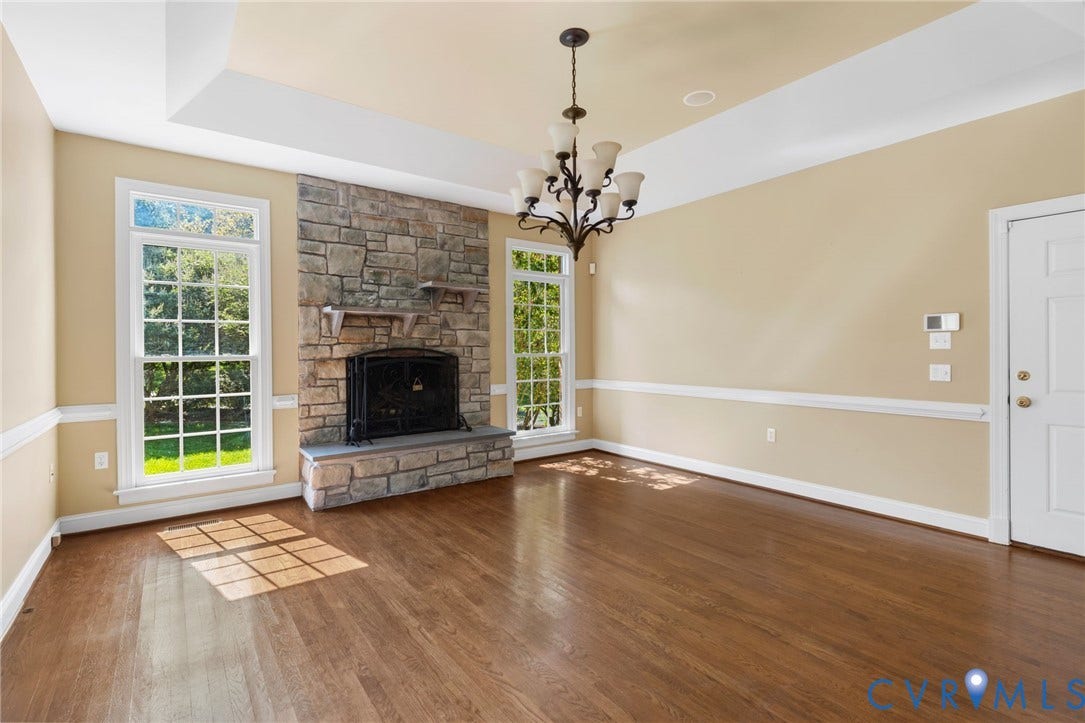 2365 Manakintown Ferry Road, Powhatan, VA 23113 Stone-clad fireplace, tray ceiling, hardwood flooring, chandelier lighting, and extensive trim work