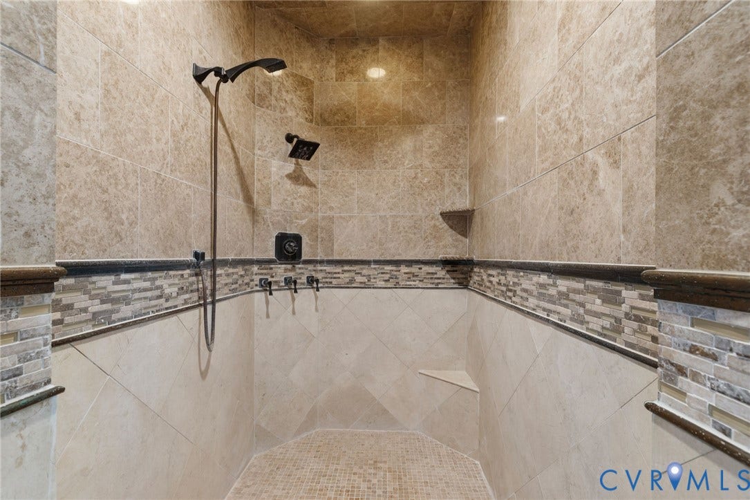 2365 Manakintown Ferry Road, Powhatan, VA 23113 Walk-in shower featuring dual shower heads, mosaic tile accents, recessed lighting, a built-in corner shelf, and a sloped floor with mosaic tile