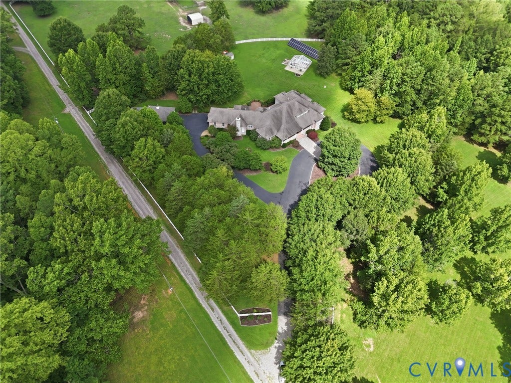 2365 Manakintown Ferry Road, Powhatan, VA 23113 Expansive grounds featuring a residential structure, mature landscaping, paved driveway, and solar panels
