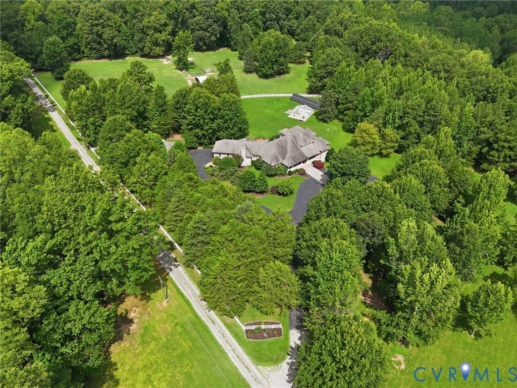 2365 Manakintown Ferry Road, Powhatan, VA 23113 Expansive property featuring a residence with a dark-pitched roof, surrounding mature trees, manicured lawns, and a paved driveway