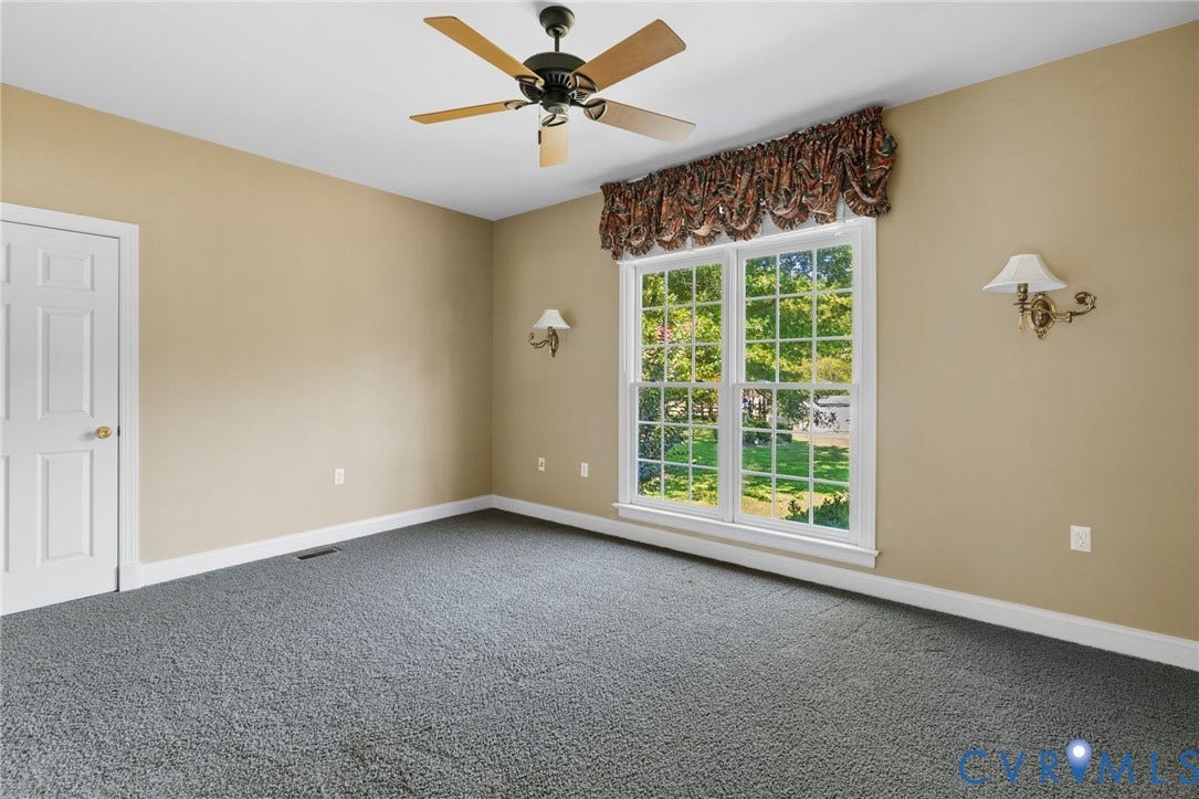 2365 Manakintown Ferry Road, Powhatan, VA 23113 Neutral wall tones, gray carpeting, a multi-pane window, and a ceiling fan with integrated lighting