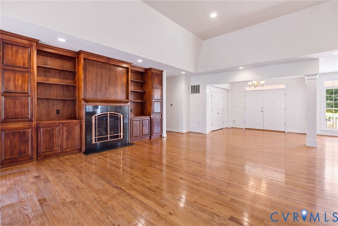 2365 Manakintown Ferry Road, Powhatan, VA 23113 Built-in custom wood cabinetry, fireplace with dark stone surround, polished wood-finish flooring, recessed lighting, and double entry doors