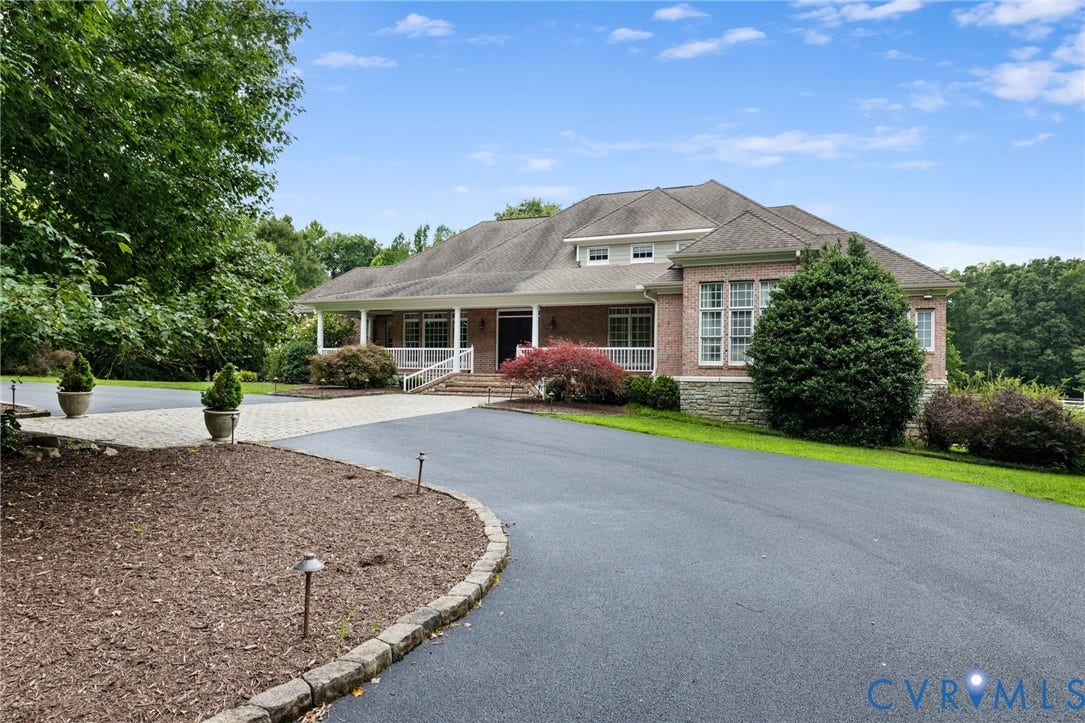 2365 Manakintown Ferry Road, Powhatan, VA 23113 Brick and stone exterior with a covered porch, white railing, multi-pane windows, and a paved driveway with a stone border