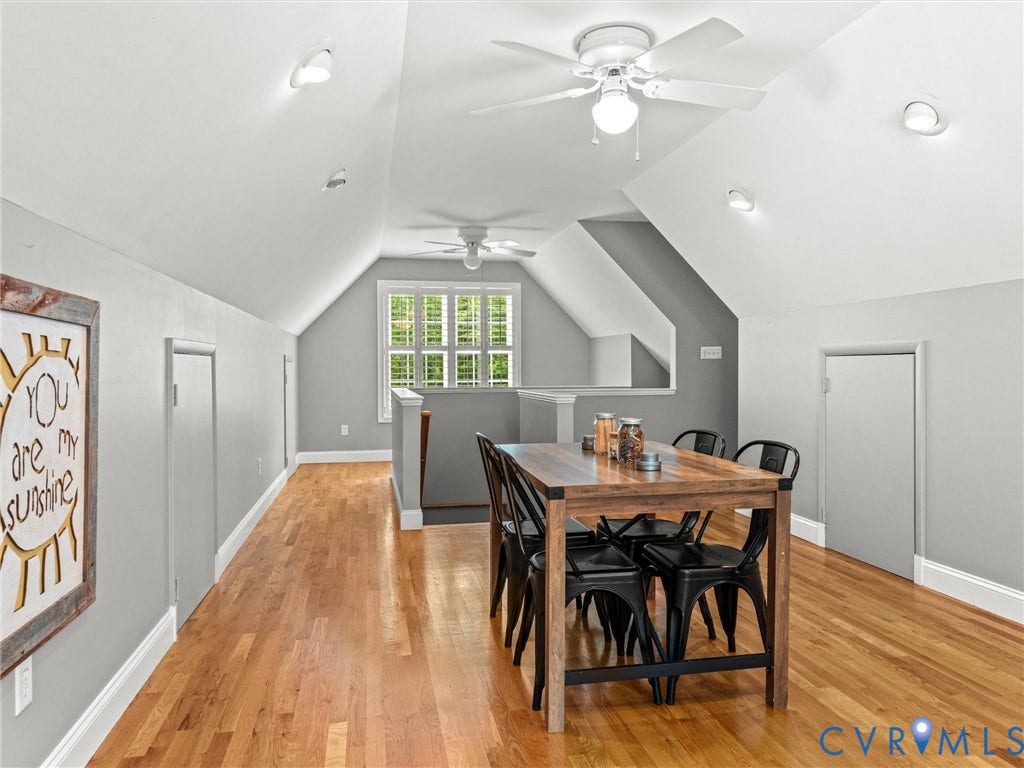 Vaulted ceiling, recessed lighting, wood-finish flooring, multiple ceiling fans, and built-in window shutters