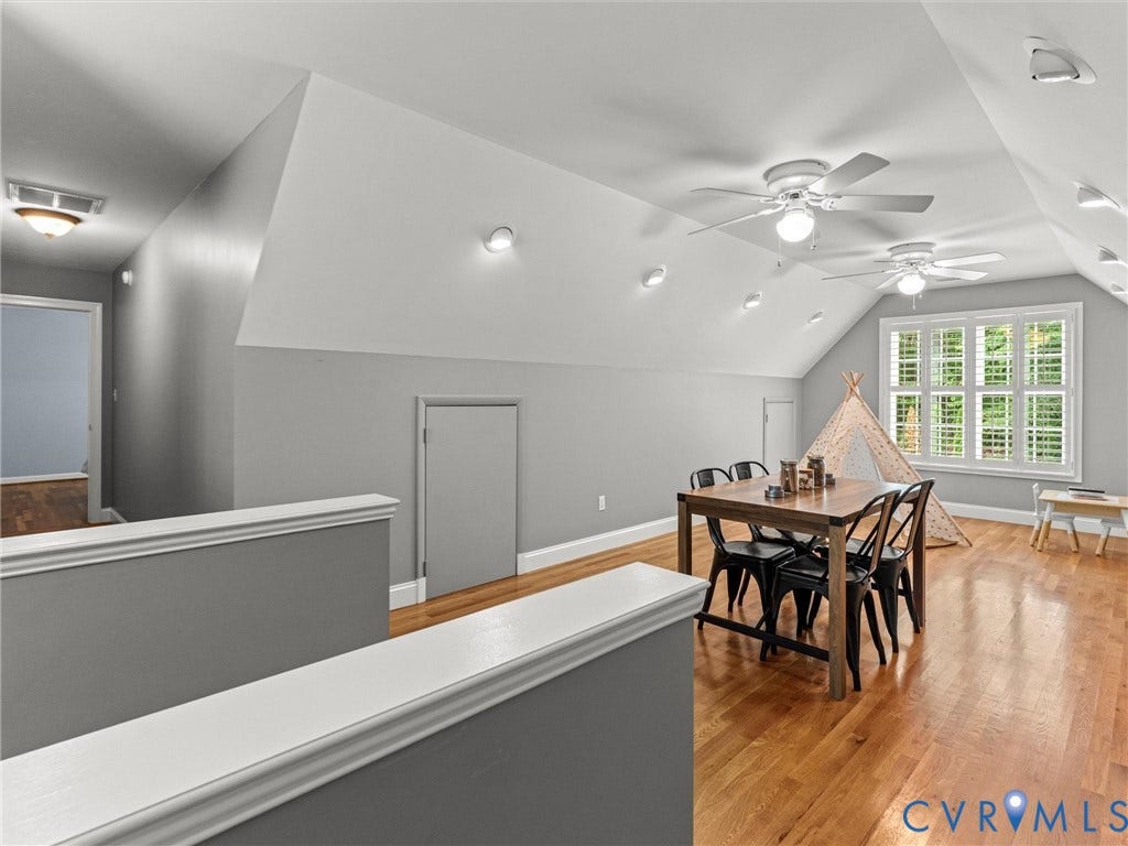 Vaulted ceiling with recessed lighting and ceiling fans, wood-finish flooring, and window with plantation shutters