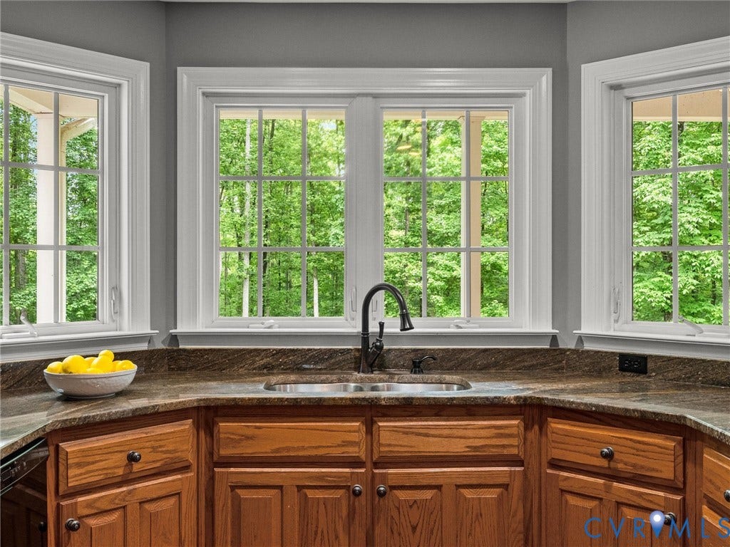 Bay window configuration with multiple casement windows and white trim