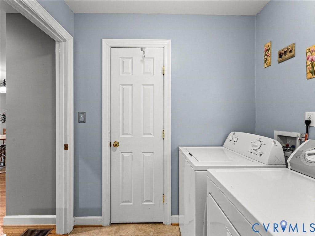 Dedicated laundry area with a top-load washing machine and a front-load dryer