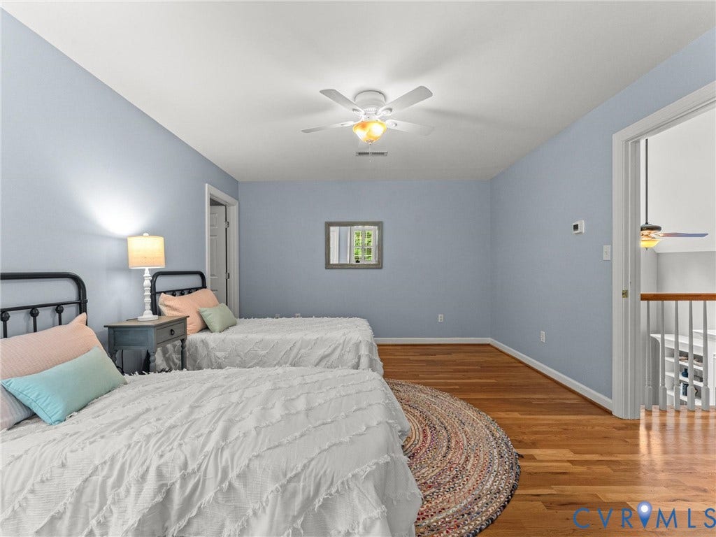Hardwood flooring, painted walls, ceiling fan, and window