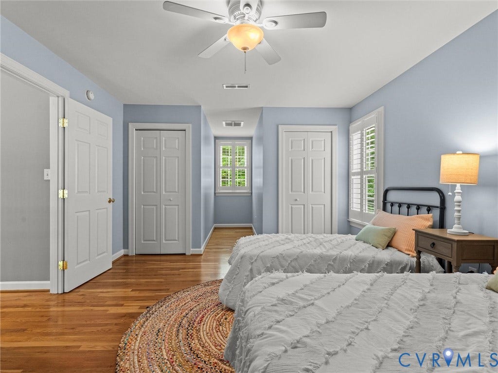 Recessed lighting, wood-finish flooring, white panel doors, and a ceiling fan with an integrated light fixture