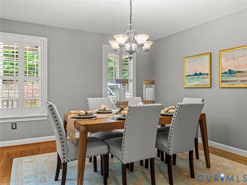 Hardwood flooring, plantation shutters, five-light chandelier, and light gray wall color