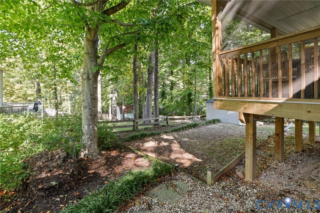13512 Master Stag Drive, Midlothian, VA 23112 Screened wooden deck with elevated support posts, timber post-and-rail fencing, and mature trees