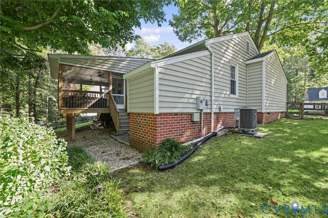 13512 Master Stag Drive, Midlothian, VA 23112 Exterior featuring light-colored horizontal siding, red brick foundation, and a rear screened porch with wooden framing