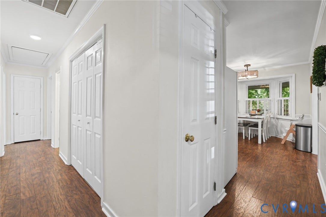 13512 Master Stag Drive, Midlothian, VA 23112 Hallway featuring wood-finish flooring, white panel doors, and recessed lighting, with a bay window providing natural light in the rear area