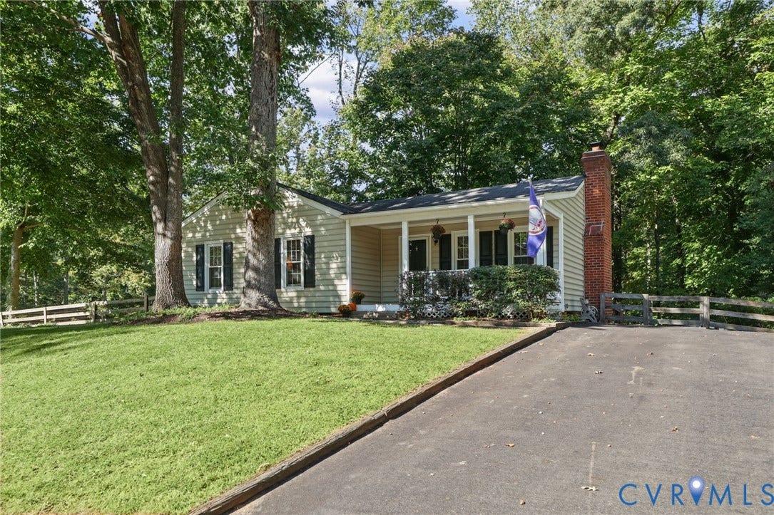 13512 Master Stag Drive, Midlothian, VA 23112 Ranch-style exterior featuring light-toned siding, a covered front porch with railings, a brick chimney, an asphalt driveway, and split-rail perimeter fencing