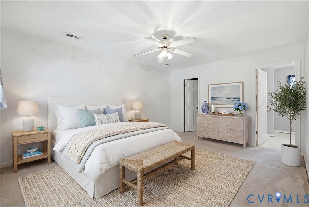 13308 S Chester Road, Chester, VA 23831 Serene primary bedroom showcasing a ceiling fan with integrated lighting, dual nightstands with task lamps, and neutral wall finishes