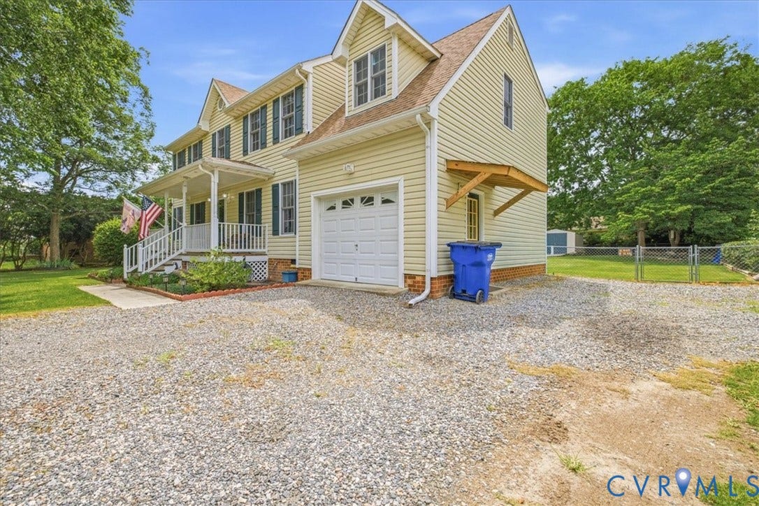 13308 S Chester Road, Chester, VA 23831 Charming Colonial-style home featuring cream-colored vinyl siding, multiple gabled rooflines with architectural detail, and a two-car garage