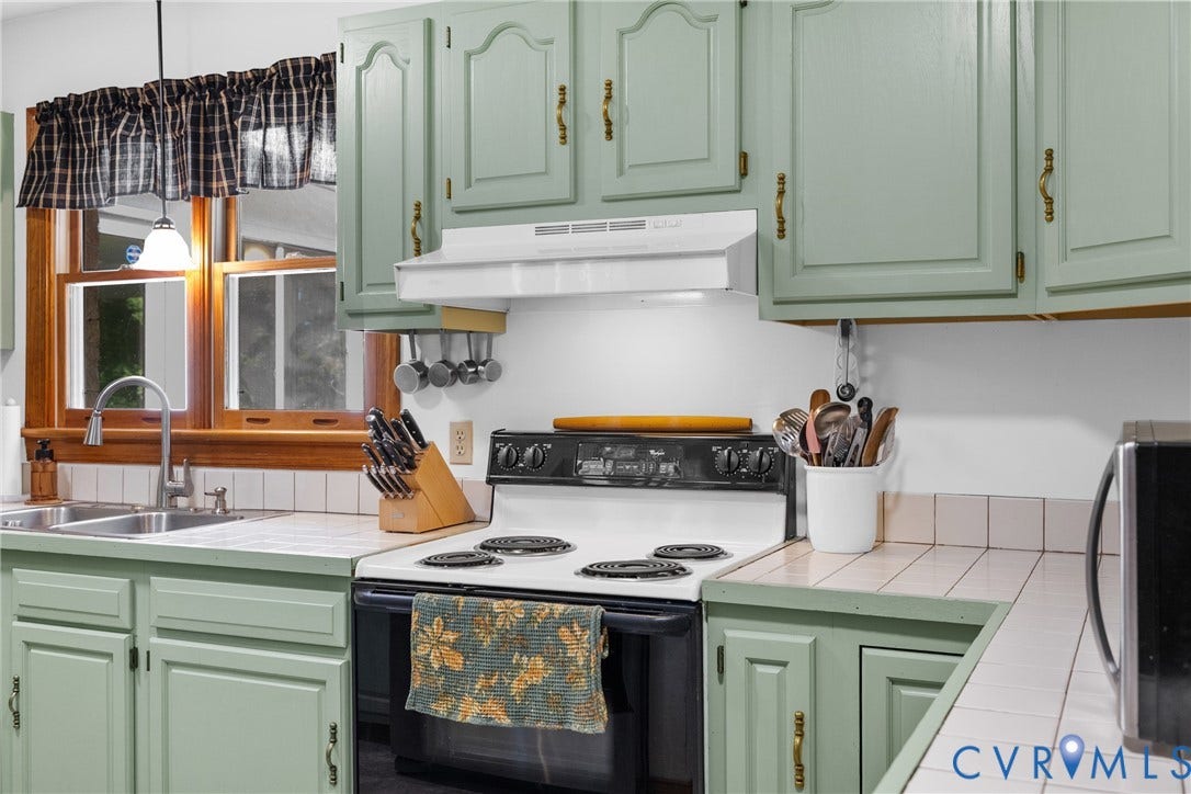 3621 Jefferson Highway, Rual, Mineral, VA 23093 Kitchen featuring pale green cabinetry, white tiled countertops, and a stainless steel sink with a gooseneck faucet