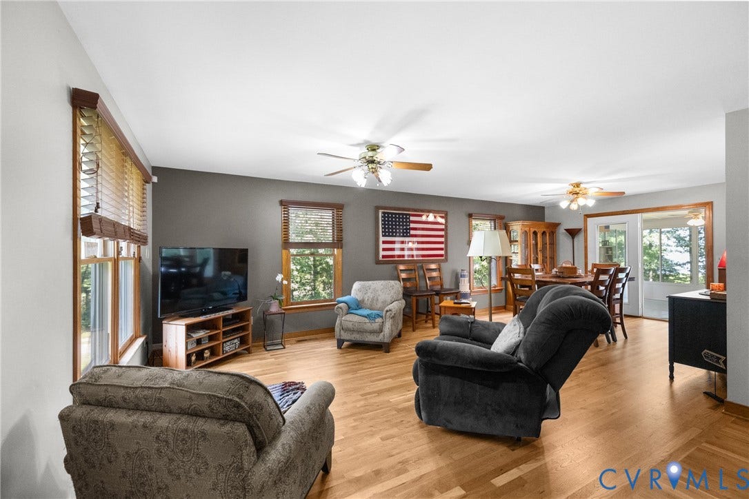 3621 Jefferson Highway, Rual, Mineral, VA 23093 Hardwood flooring, multiple windows with natural wood trim, sliding glass door, and ceiling fans