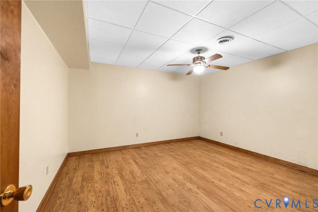 3621 Jefferson Highway, Rual, Mineral, VA 23093 Wood-finish flooring with coordinating baseboards, neutral wall color, and a ceiling fan with integrated lighting