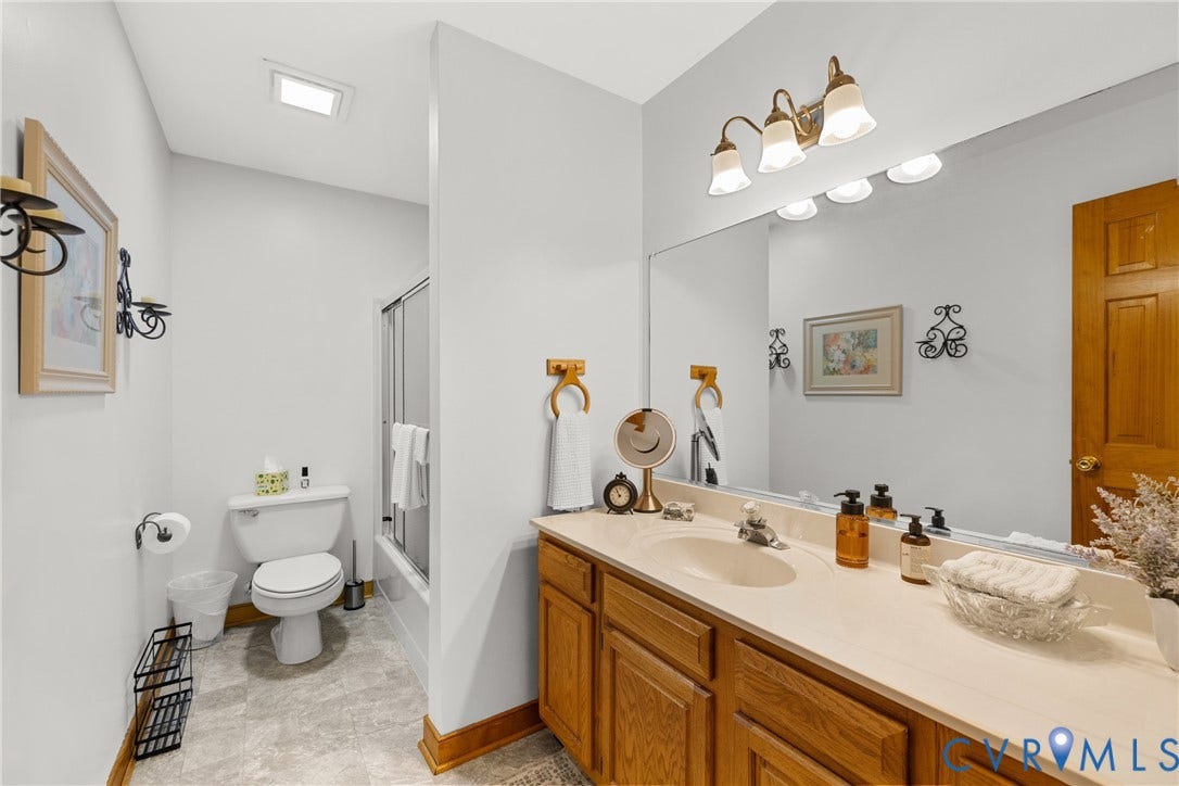 3621 Jefferson Highway, Rual, Mineral, VA 23093 Extended vanity with an integrated sink and large mirror, accented by a four-light fixture