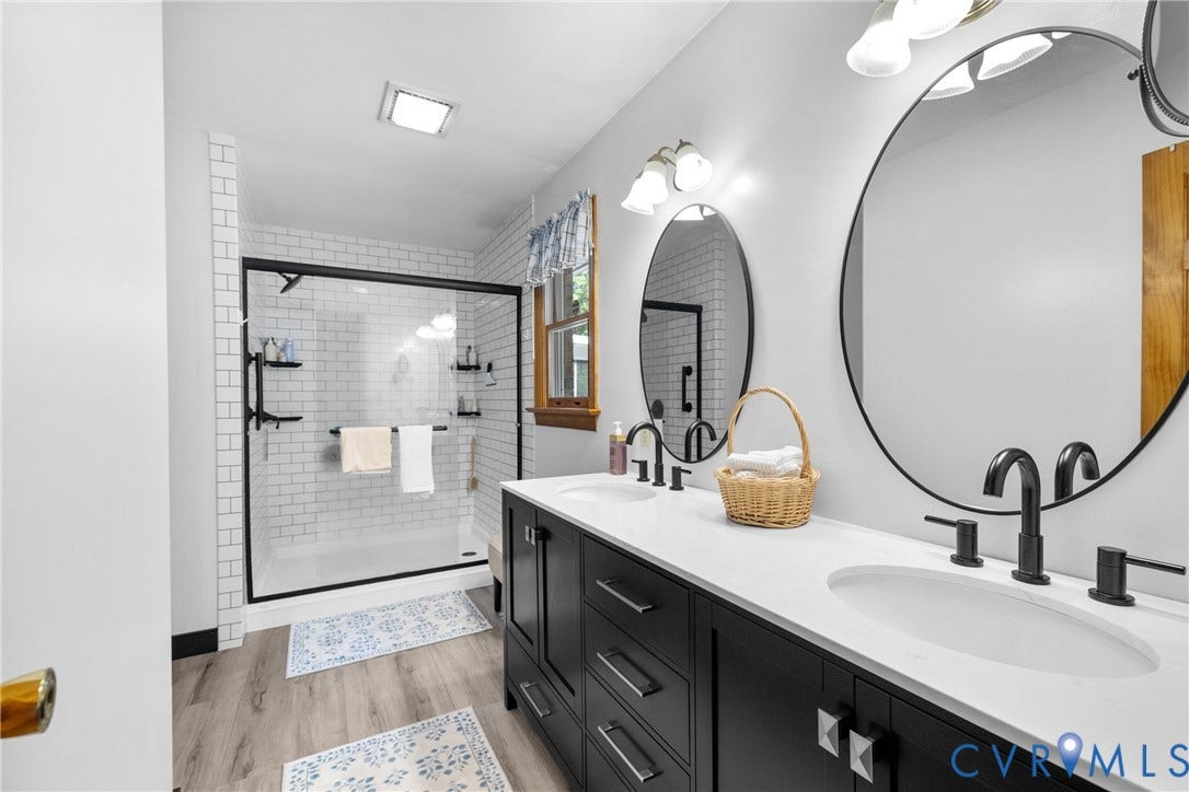 3621 Jefferson Highway, Rual, Mineral, VA 23093 Dual vanity with white countertops, matte black fixtures, and wood-finish flooring