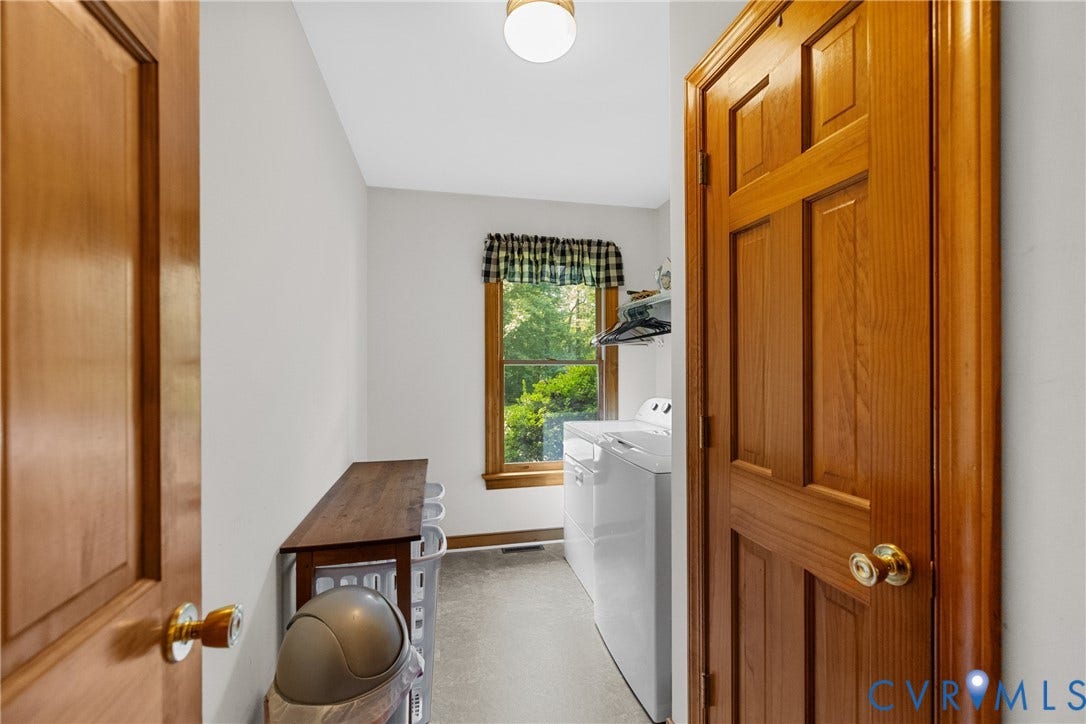 3621 Jefferson Highway, Rual, Mineral, VA 23093 Laundry room featuring wood-finish cabinetry, tile flooring, and abundant natural light from a casement window