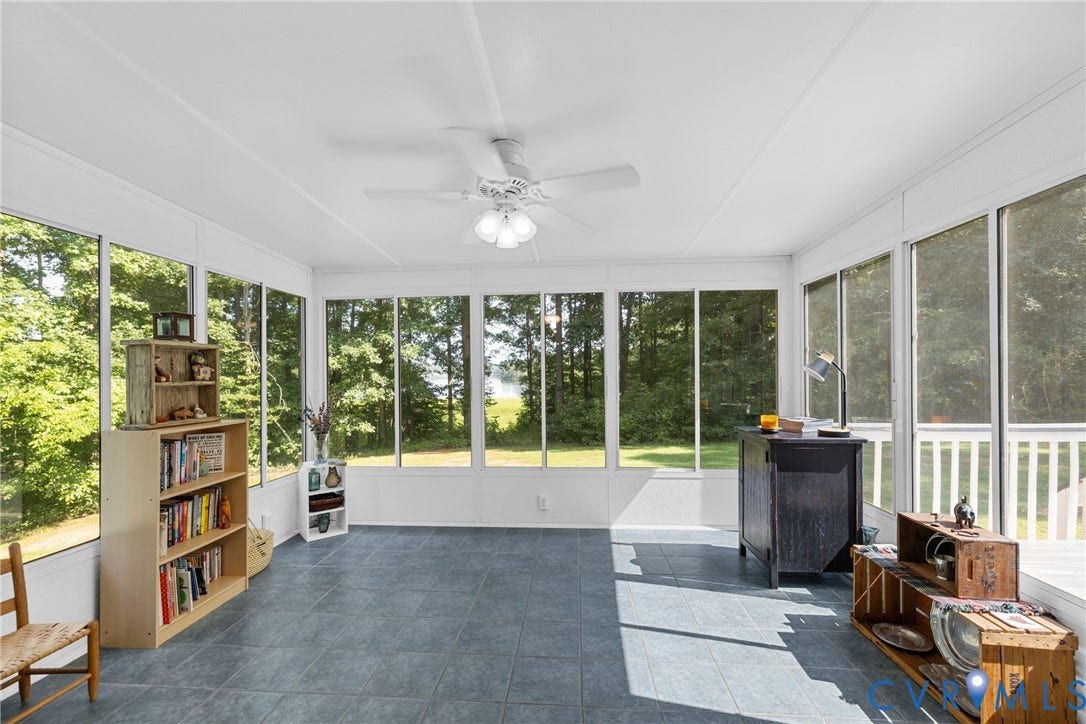 3621 Jefferson Highway, Rual, Mineral, VA 23093 Spacious sunroom featuring extensive window panels, a ceiling fan with integrated lighting, and durable tile flooring