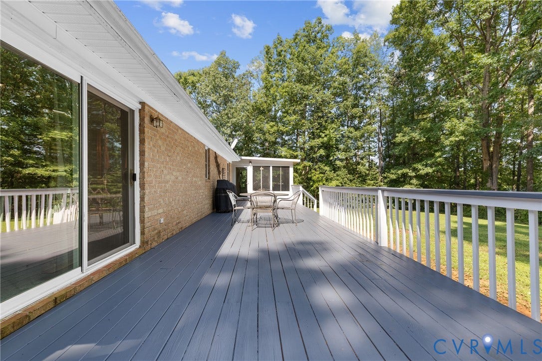 3621 Jefferson Highway, Rual, Mineral, VA 23093 Expansive composite deck featuring gray composite decking with white aluminum railings, extending across the full width of the home