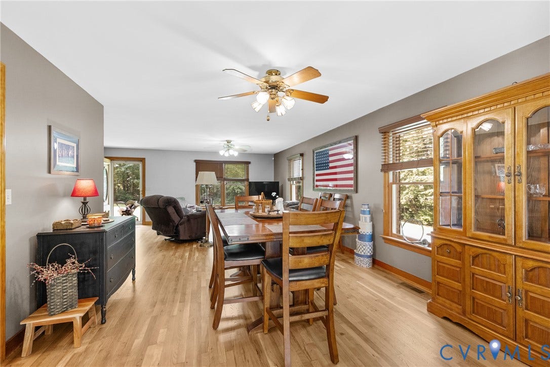 3621 Jefferson Highway, Rual, Mineral, VA 23093 Hardwood-finish flooring throughout, featuring a ceiling fan with integrated lighting, natural wood trim, and a built-in display cabinet
