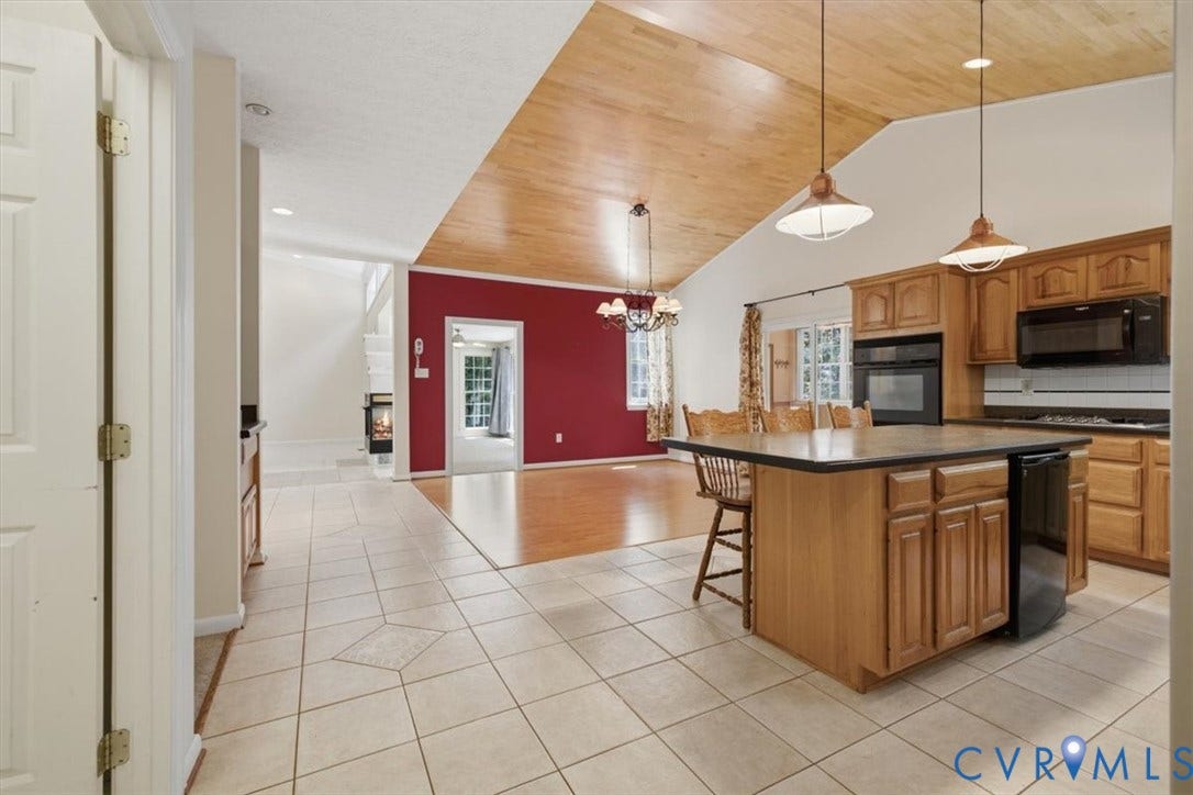 12600 Lilking Road, Chester, VA 23831 Spacious kitchen featuring wood cabinetry, stainless steel appliances, and a substantial island with seating