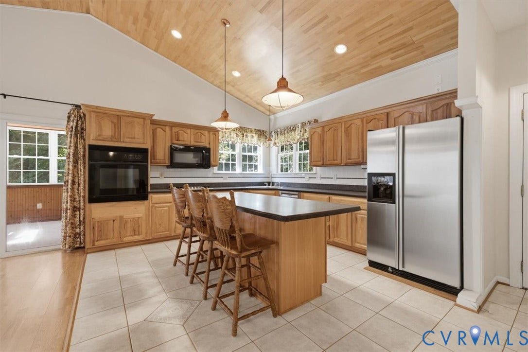 12600 Lilking Road, Chester, VA 23831 Spacious kitchen featuring custom wood cabinetry, stainless steel appliances, and a large center island with seating for multiple guests