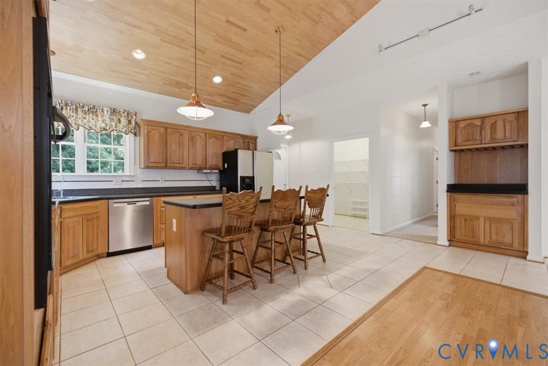 12600 Lilking Road, Chester, VA 23831 Spacious kitchen featuring wood cabinetry, stainless steel appliances, and a center island with seating