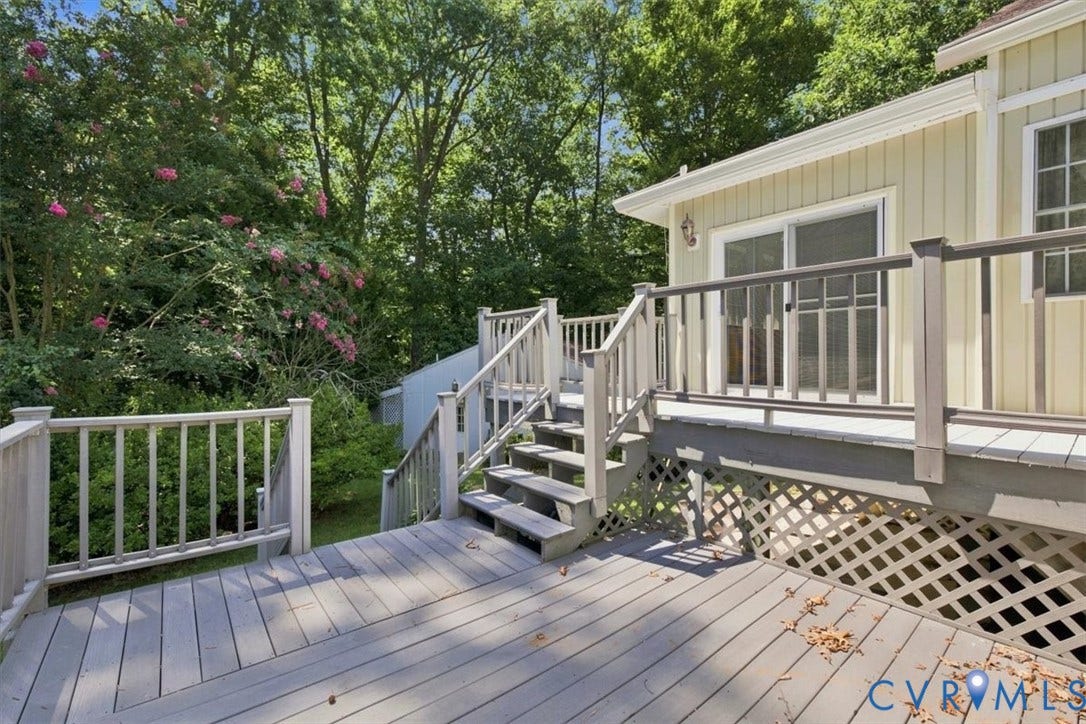 12600 Lilking Road, Chester, VA 23831 Expansive composite deck featuring multiple levels with white railings, hardwood-finish decking, and integrated lattice skirting