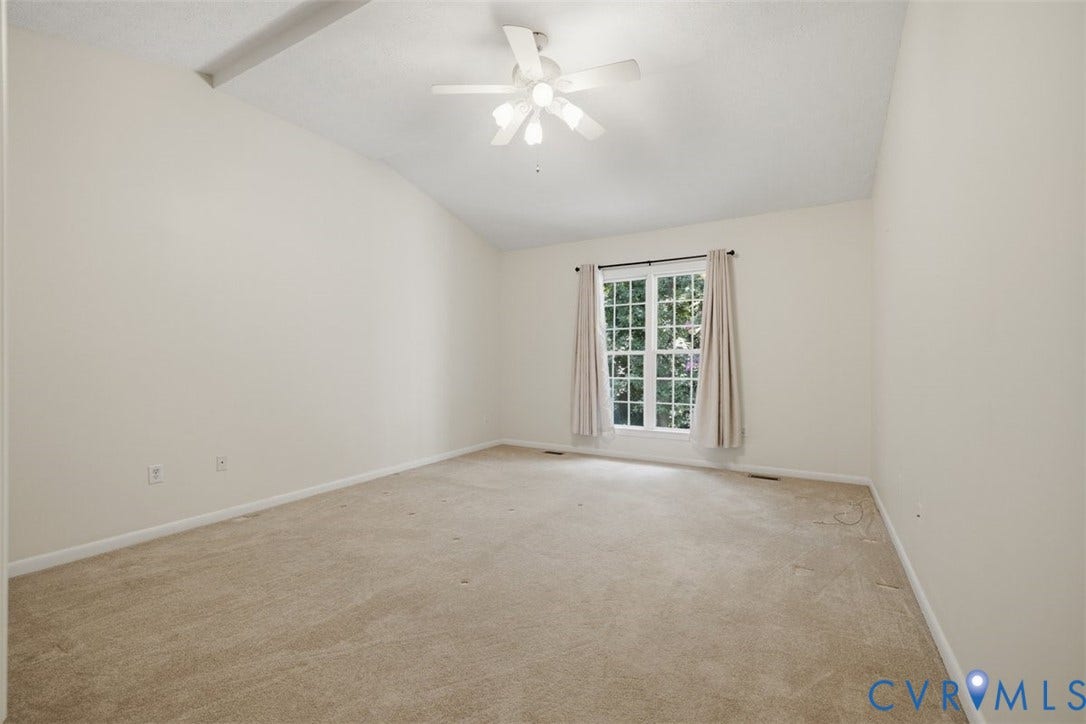 12600 Lilking Road, Chester, VA 23831 Bright bedroom featuring neutral carpet flooring, ceiling fan with integrated lighting, and glass door with curtain panels providing natural light from the exterior window frame