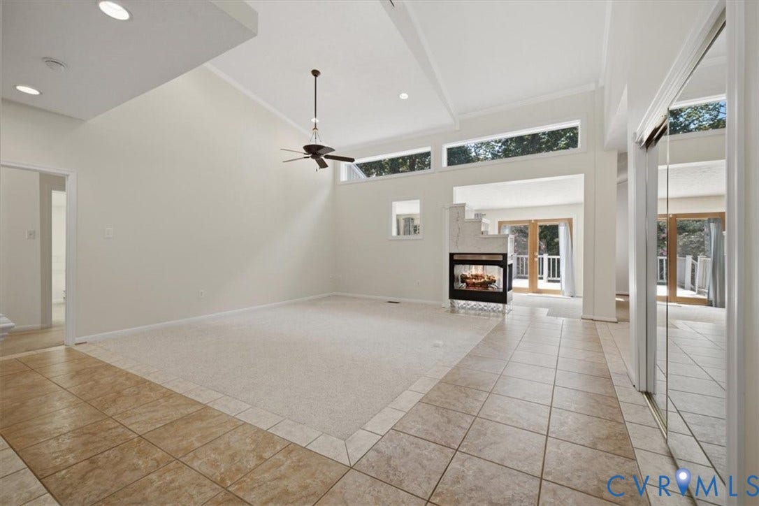 12600 Lilking Road, Chester, VA 23831 Spacious great room with soaring vaulted ceilings, clerestory windows flooding the space with natural light, and a ceiling fan for climate control