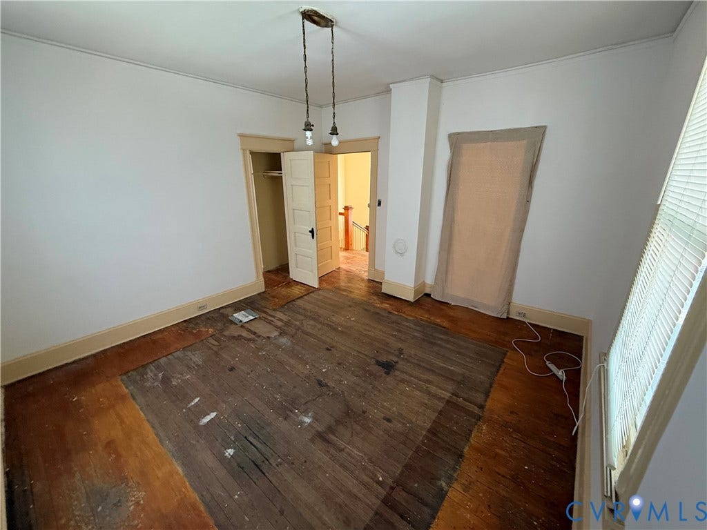 1313 Enfield Avenue, Richmond, VA 23224 Interior room with wood-finish flooring, white walls, and a recessed closet