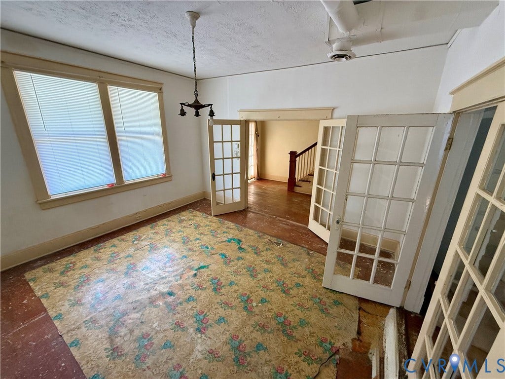 1313 Enfield Avenue, Richmond, VA 23224 French doors with multiple lites, double windows with blinds, and a ceiling-mounted light fixture
