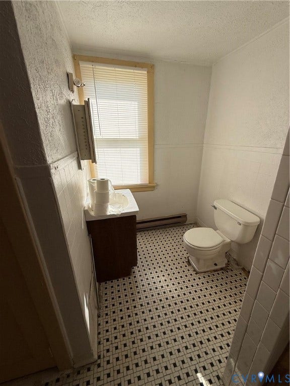 1313 Enfield Avenue, Richmond, VA 23224 White toilet and a vanity with a white countertop