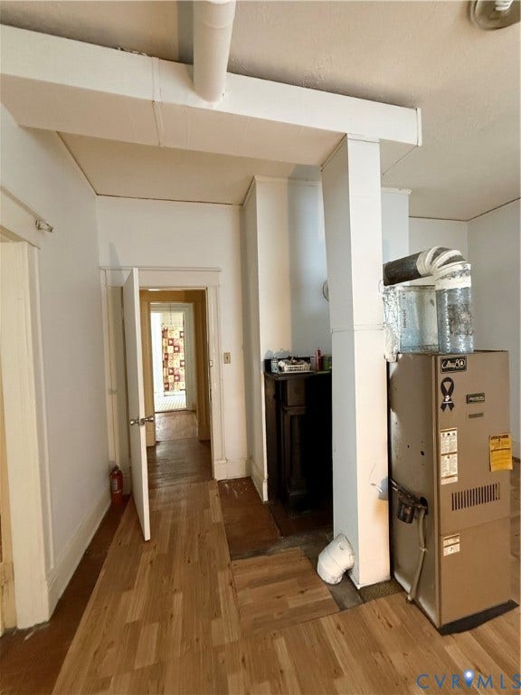 1313 Enfield Avenue, Richmond, VA 23224 Wood-finish flooring with a central utility area, featuring a built-in dark wood cabinet and white walls