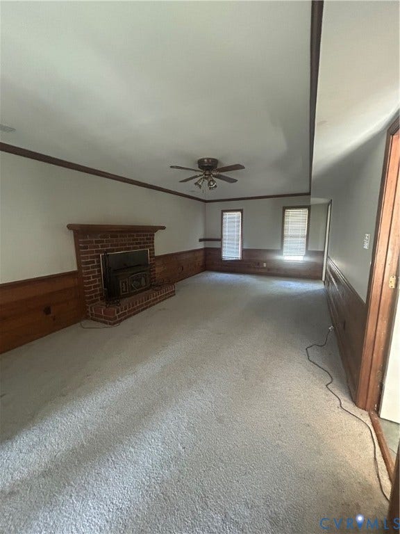 10641 Cliffmore Drive, Glen Allen, VA 23060 Brick fireplace with a wood mantel, wood paneling, ceiling fan light fixture, and carpeted flooring