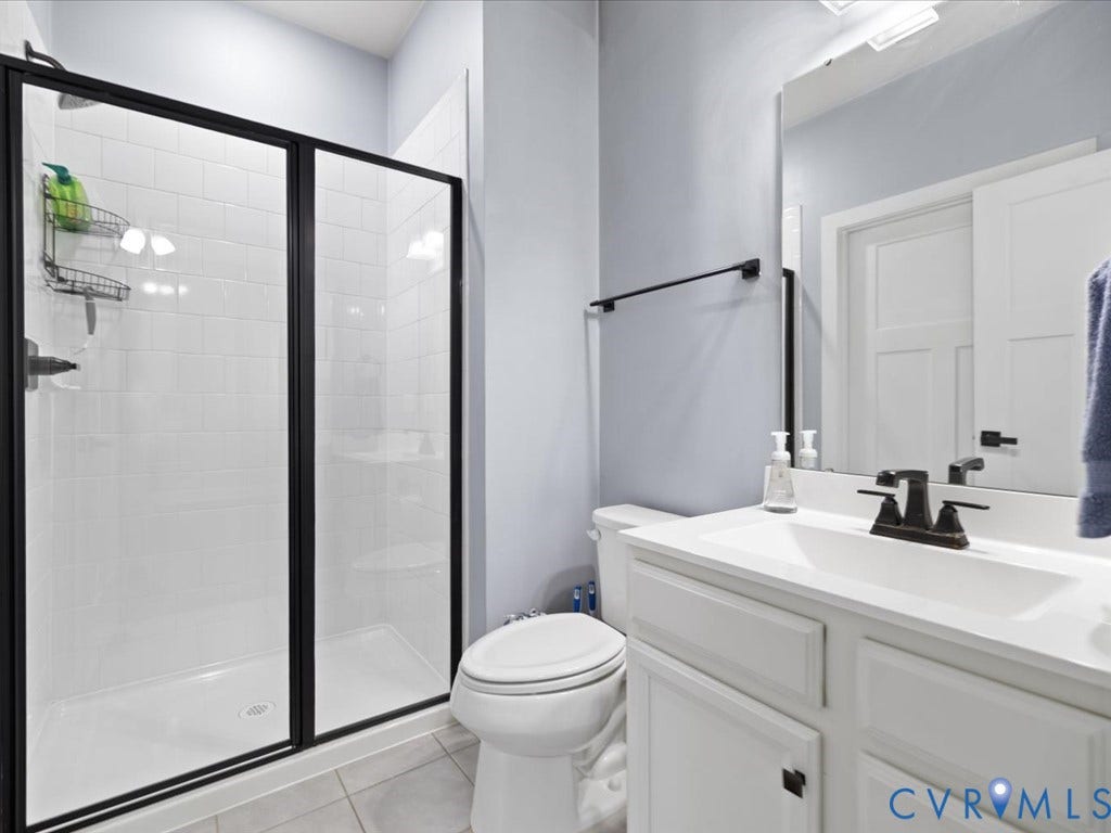 Walk-in shower with black-framed glass enclosure