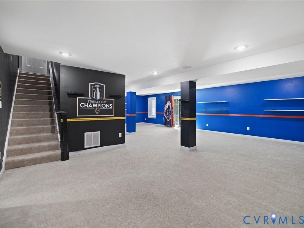 Expansive finished lower level featuring recessed lighting, carpeting, and vibrant accent walls